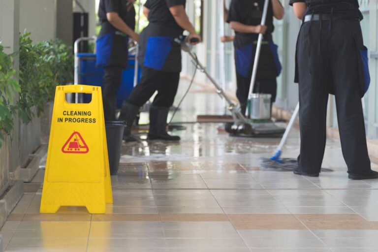 Commercial cleaning people mopping office floor