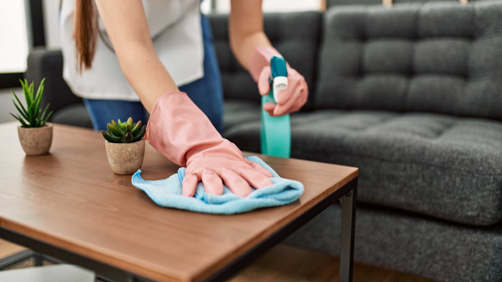 Residential cleaning woman dusting table