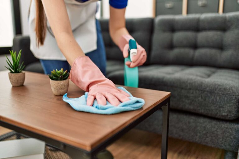 Residential cleaning woman dusting table