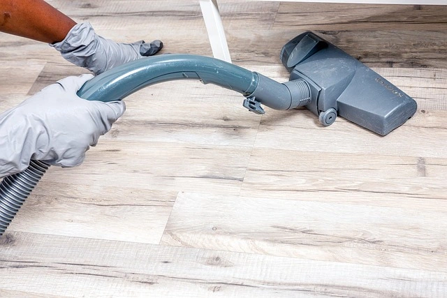 Vacuuming hardwood floors as part of routine house cleaning maintenance
